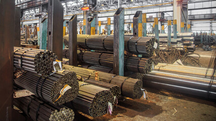 Hot rolling steel in warehouse of iron foundry.