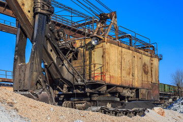 Old excavator in a quarry at a steel mill.