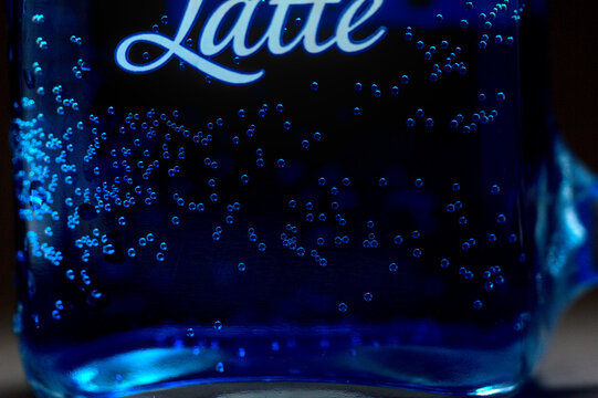 blue colored fizzy drink bubbles in glass cup, can be used for design and texture