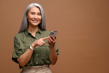 Happy business woman touching to the smartphone screen while feeling great with new phone features....