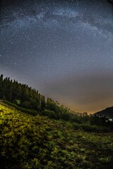 Plakat Mountain landscape with starry sky and milky way
