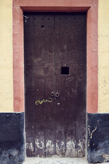 Old, picturesque main front door in mediterranean region house