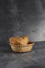 bukens in a wicker basket isolated on gray background