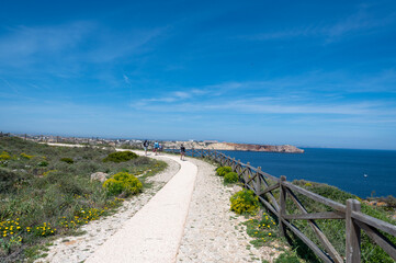 Fototapeta premium People walking through the Fortaleza de Sangre in the Algarve, Portugal in summer.