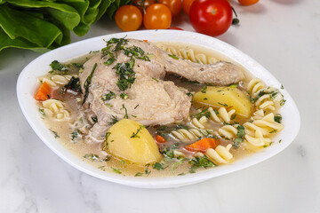 Chicken soup with leg and macaroni