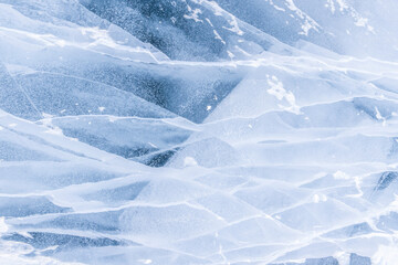 Frozen ice background. Texture of the blue ice. Winter abstract background. Frozen Baikal lake. Ice cracks.