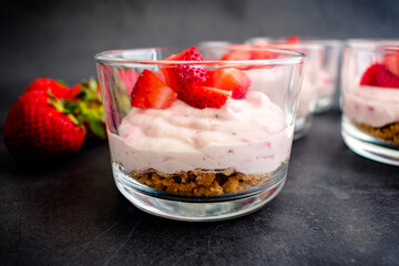 Closeup View of Strawberry Cheesecake Mousse: Side view of a fruit dessert served in a glass bowl