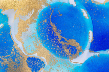 Alcohol-based ink texture in blue tones with gold.