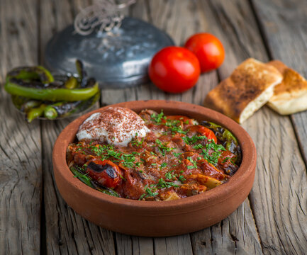 Iskander Kebab served in dish side view on wooden table background