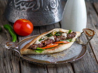 kebab sandwich served in dish side view on wooden table background