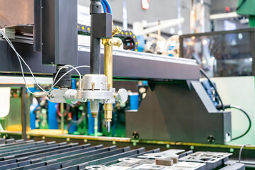 Close up nozzle head of high precision cnc gas plasma cutting machine for manufacturing process cut...