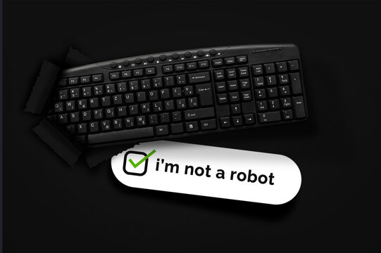 PC keyboard with i'm not a robot box on black background. Innovation or creative concept