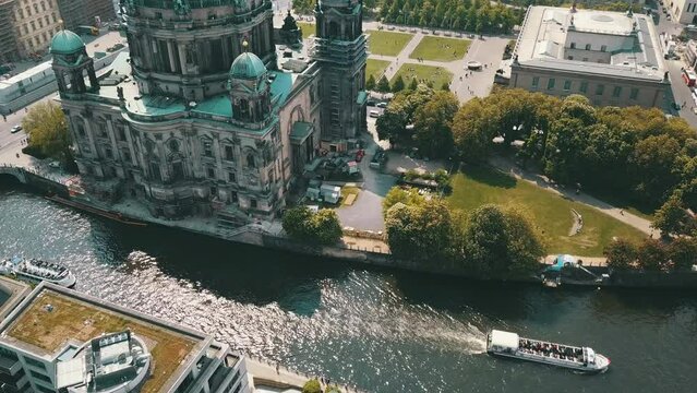 Tilt footage near dome of Berlin Cathedral. Aerial view of Lustgarten park and busy street around Berlin Palace. Berlin, Germany.