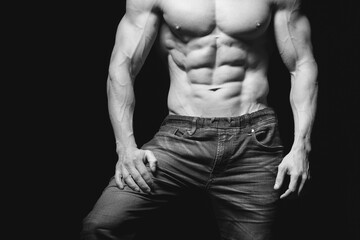 Fitness concept. Muscular and fit torso of young man having perfect abs, bicep and chest. Male hunk...