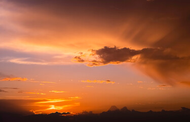 Naklejka premium Dramatic orange sunset sky. Beautiful textural background of the sunset and clouds...