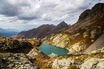 Obraz premium Moraine lake in Caucasus national park surrounded by alpine landscape, peaks of rocky mountains and limestone geological formations. Caucasus nature reserve.