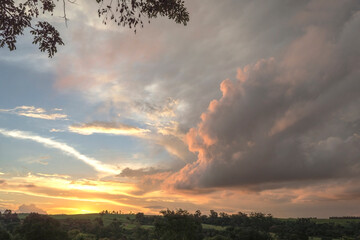 Countryside landscape showing dramatic sunset with lots of clouds and colors