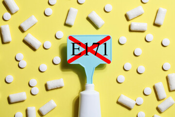 Titanium dioxide, E171, dangerous additive concept. gum, pills, toothpaste or cream and sign with...
