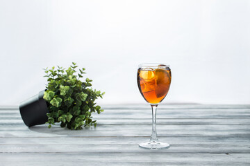 wine glass of aperol spritz cocktail on wooden table on white background