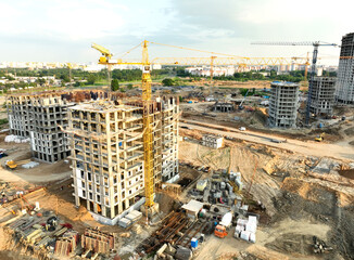 Сonstruction site with tower cranes on building construction. Builder on formworks. Cranes on...