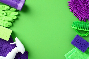 Cleaning products on green background. House cleaning service and housekeeping concept. Flat lay, top view, copy space.
