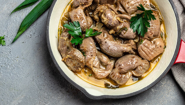 Stewed chicken stomach, Traditional Korean spicy chicken gizzard with onions, garlic, chili and sesame on a dark background, place for text, top view