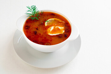 Traditional Russian meat soup Solyanka in bowl isolated on white background. A great product for your menu.