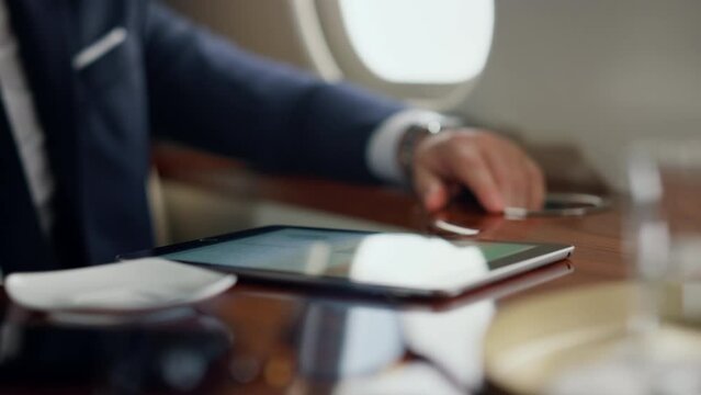Man hand taking coffee cup resting on jet. Digital computer on table closeup