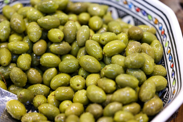  green olives in an old ceramic bowl