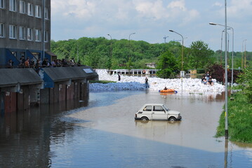 Wrocław, Kozanów housing estate, flood of May 2010. You can see residential buildings and a car standing in the water. - obrazy, fototapety, plakaty