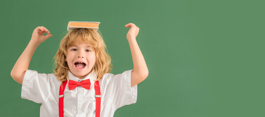 School pupil boy on blackboard, banner copy space. cheerful kid boy in bow tie in school classrrom...