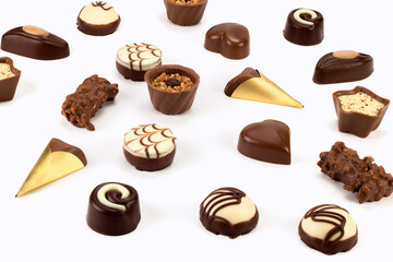 Collection of delicious chocolate pralines isolated on bright background. Close up view.