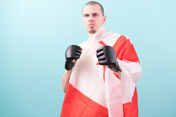 A confident MMA fighter in black gloves and a Canadian flag ready to fight on a blue background....