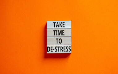 Take time to de-stress symbol. Concept words Take time to de-stress on wooden blocks. Beautiful orange table orange background. Psychological business and take time to de-stress concept. Copy space.