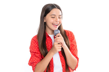 Happy cute teen girl singing a song on microphone. Close-up portrait of trendy fashionable girl...
