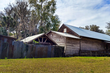 Wooden Old Barn House With Blue Sky and Green Yard