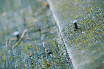 Nails coming out on an old wooden roof.