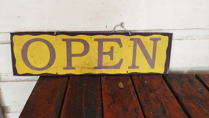 Open Wood Sign on a Wooden Table in Yellow and Purple