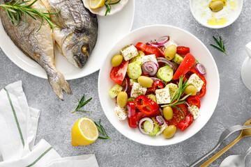 Greek salad, baked dorada fish sea bream and tzatziki dip. Healthy food. Mediterranean diet