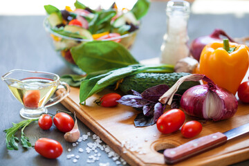 Juicy vegetables on a board and salad in a bowl