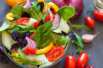 Juicy vegetables on a board and salad in a bowl