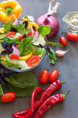 Juicy vegetables on a board and salad in a bowl