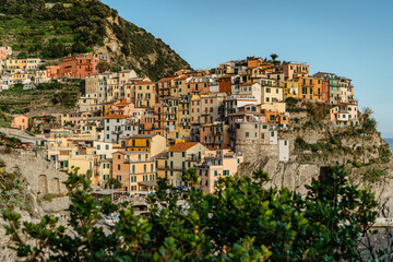 Fototapeta na wymiar View of Manarola,Cinque Terre,Italy.UNESCO Heritage Site.Picturesque colorful village on rock above sea.Summer holiday,travel background.Italian Riviera landscape.Houses on steep cliff,vineyards