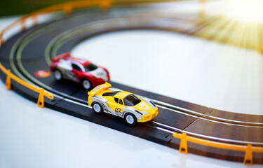 Toy cars go in a circle. Riding a race. The racing car surges forward.Car racing. Children's cars...