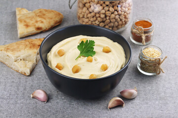 Hummus traditional oriental vegan sauce from chickpea and ingredients. Healthy food. Selective focus