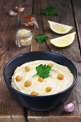 Hummus traditional oriental vegan sauce from chickpea and ingredients. Healthy food. Selective focus