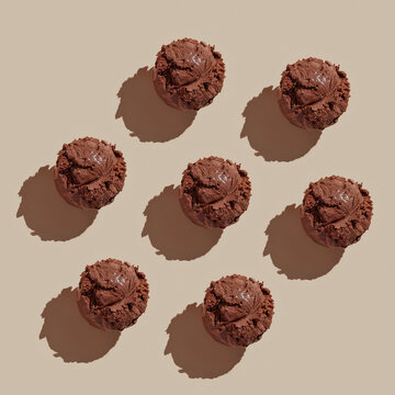 Ice cream balls pattern with copy space on a pastel brown background. Summertime, dessert minimal concept. Top view. Chocolate , hard light
