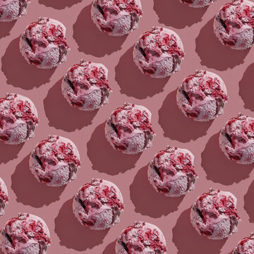 Ice cream balls pattern with copy space on a pink background. Summertime, dessert minimal concept. Top view. Blueberry gelato with wild berries, hard light