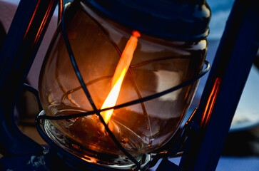 Kerosene lantern lamp with bright flame close up