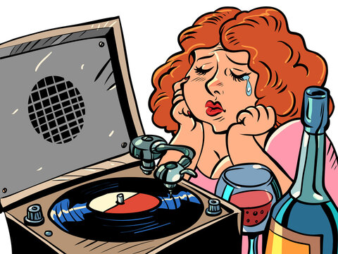 Sad red-haired woman listens to music on the gramophone and drinks wine. Lonely evening. Plate
